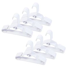 five white plastic clothes clips on a white background