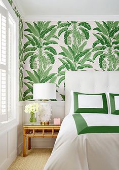 a bedroom with green and white wallpaper