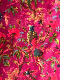 a pink background with colorful flowers and birds on it's sides, all over