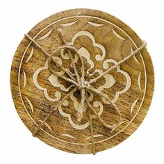 a piece of wood that has been carved into a circle with an intricate design on it