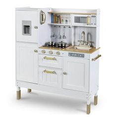 a toy kitchen with white cabinets and wooden floors