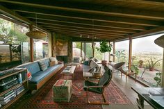 a living room filled with furniture and lots of windows