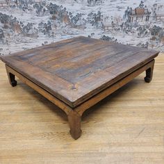 an old wooden table sitting on top of a hard wood floor