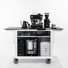 a coffee maker on wheels is shown in front of a white background with black accents