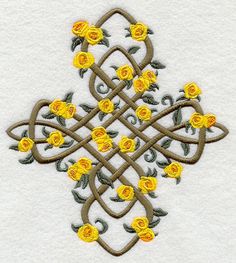 a cross with yellow roses on it is in the shape of an intricate design,