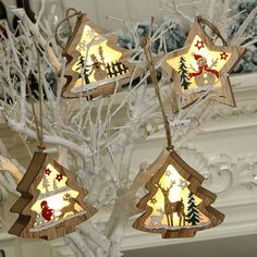 four wooden christmas trees with lights on them