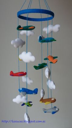 a wind chime with airplanes and clouds hanging from it