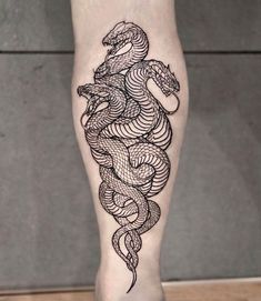 a woman's leg with a tattoo on it and a snake in the middle