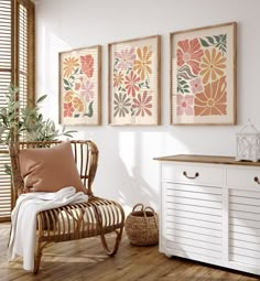 three framed art prints hang on the wall above a white dresser and sideboard in a room with wood flooring