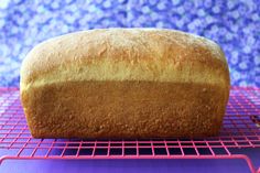 a loaf of bread sitting on top of a pink rack