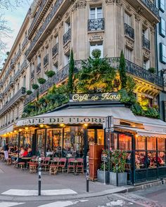 an outdoor cafe with plants growing on the roof