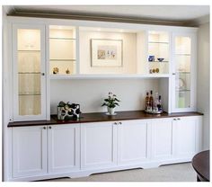 a white cabinet with glass doors and shelves