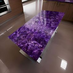 a kitchen with purple marble counter tops and stainless steel appliances