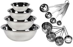 stainless steel mixing bowls and measuring spoons on a white background with utensils