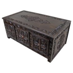 an ornate wooden box with carvings on it