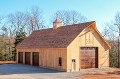 a barn with two garages and a steeple on top