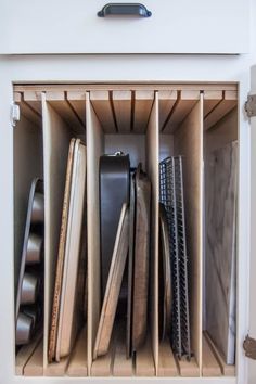 an open cabinet filled with lots of different types of knives and other things in it