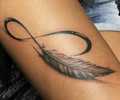 a woman's leg with a tattoo on it that has an arrow and a feather