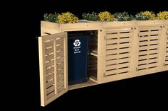 a wooden planter with plants growing out of it's sides and the doors open