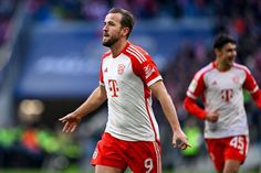 two soccer players in red and white uniforms