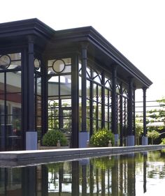 the building has many windows and is reflecting in the water