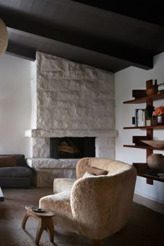 a living room filled with furniture and a fire place