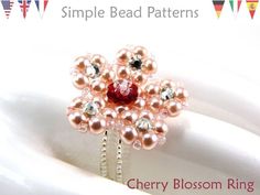 an image of a brooch with pearls on it and the words cherry blossom ring