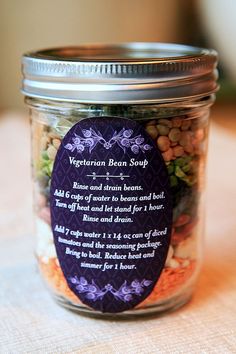 a jar filled with lots of different types of beans and other things on top of a table