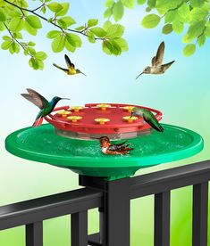 birds are flying around a bird feeder on a deck with trees and blue sky in the background