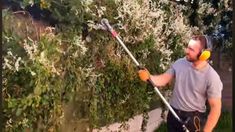 a man with headphones on is using a garden mop