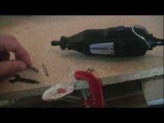 a person is working with some tools on the counter top in front of a drill and pliers