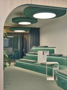 the interior of an office with green and white furniture