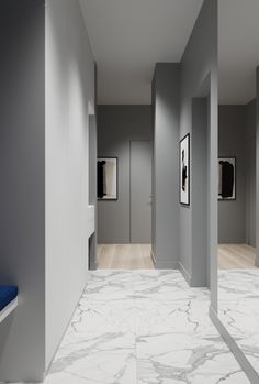 an empty hallway with white marble floors and blue bench in the center, surrounded by gray walls