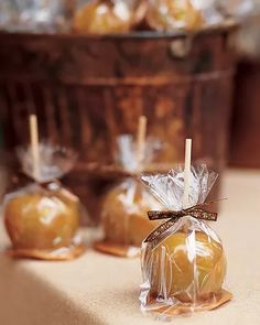 apples wrapped in plastic sitting on a table