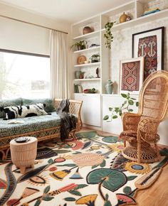 a living room filled with lots of furniture and decor on top of a hard wood floor