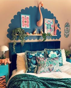 a bed room with a neatly made bed and some pictures on the wall above it