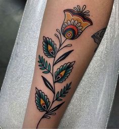 a colorful flower tattoo on the arm