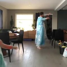 a woman in a blue dress is dancing