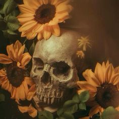 a skull surrounded by sunflowers and leaves