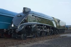 an old train is sitting on the tracks