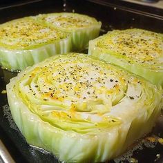 four pieces of artichoke sitting on top of a pan covered in seasoning