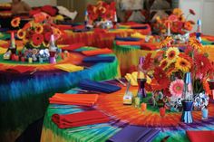 colorful table cloths and centerpieces are arranged on round tables