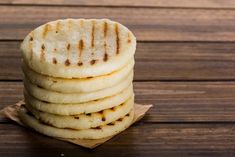 a stack of pita bread sitting on top of a wooden table