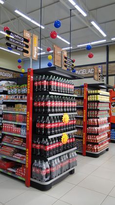 an aisle in a grocery store filled with lots of drinks and sodas on display