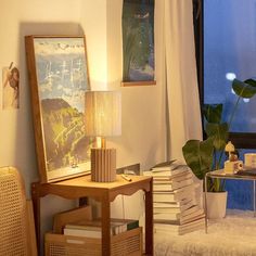 a living room filled with furniture next to a window and a lamp on top of a table