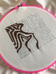 a close up of a embroidery on a white cloth