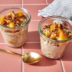 two jars filled with oatmeal sitting on top of a pink tile floor