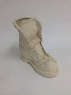 an old pair of white shoes on a white surface