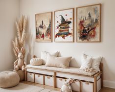 a living room filled with furniture and paintings on the wall above it's windows