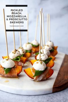 small appetizers are arranged on a platter with toothpicks in them